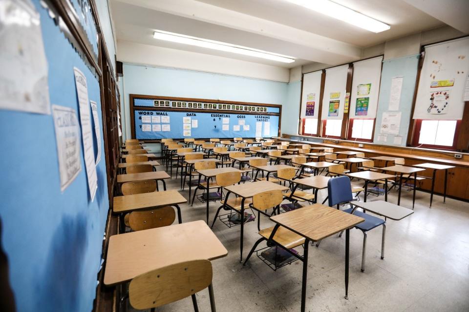 An empty classroom with desks.