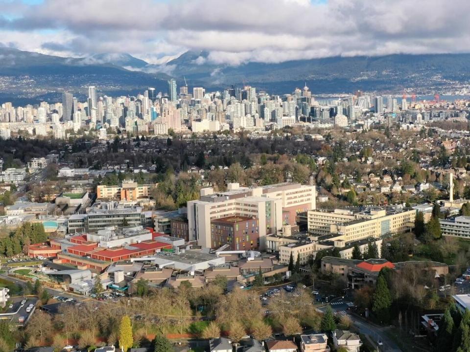 An aerial view of the B.C. Women's Hospital with the Vancouver skyline in the background. Police used a beanbag gun to shoot a female patient wielding a weapon, who was later taken into custody. (Gian Paolo Mendoza/CBC - image credit)