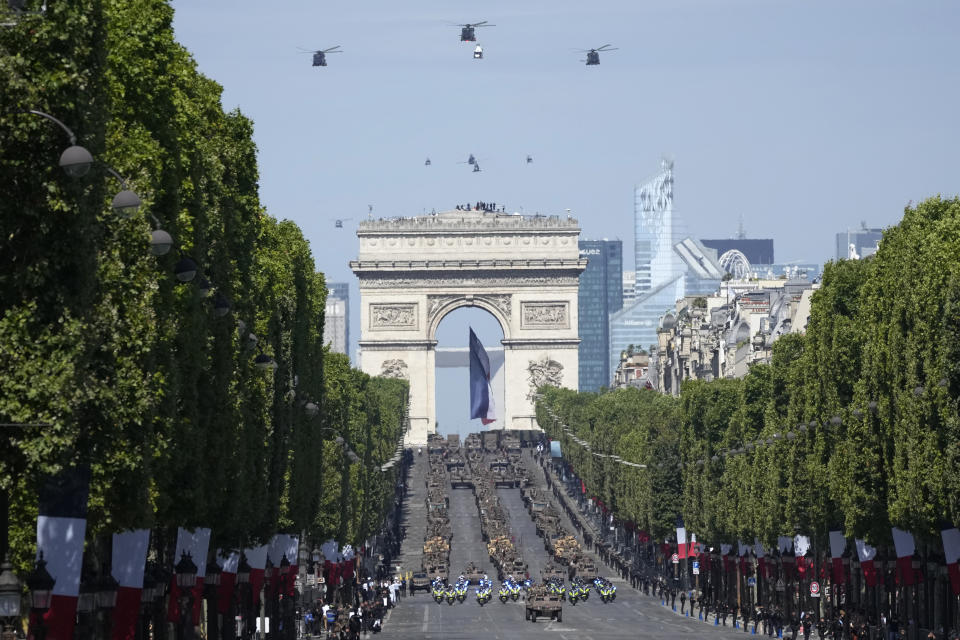 Soldiers drive military vehicles on the Champs-Elysees avenue during the Bastille Day parade in Paris, Friday, July 14, 2023. (AP Photo/Christophe Ena)