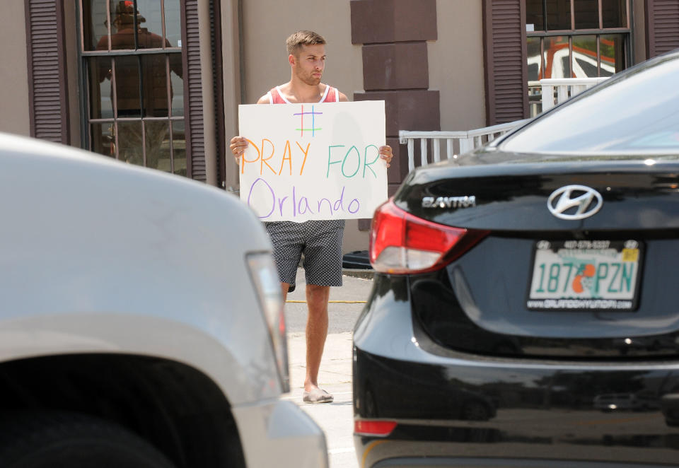 A man holds a sign in support of the victims of the terror attack at gay nightclub Pulse on June 12, 2016 in Orlando, Florida. The suspected shooter, Omar Mateen, was shot and killed by police. 50 people are reported dead and 53 were injured in what is now the worst mass shooting in U.S. history.