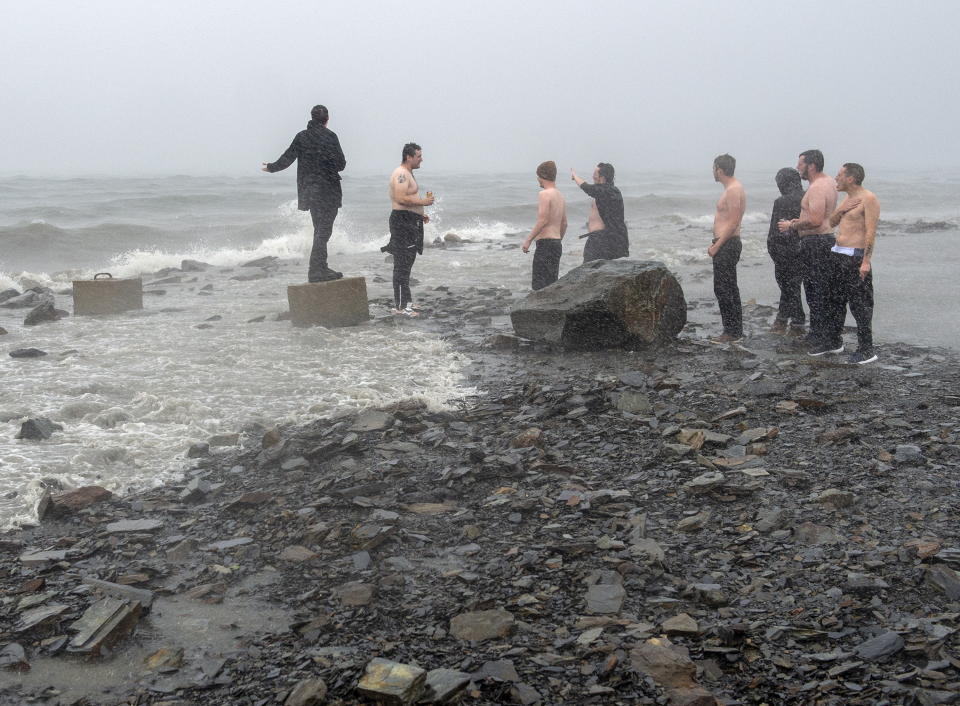 A group of friends gather along the Halifax harbor as winds from Hurricane Dorian hit Dartmouth, Nova Scotia, Canada, on Saturday, Sept. 7, 2019. (Andrew Vaughan/The Canadian Press via AP)