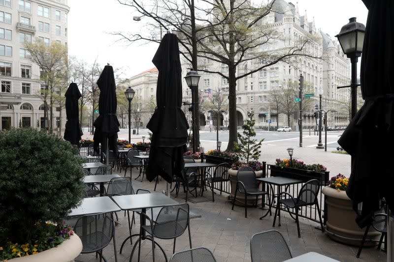 Empty restaurant tables sit on a plaza on Pennsylvania Avenue in during the coronavirus outbreak in downtown Washington