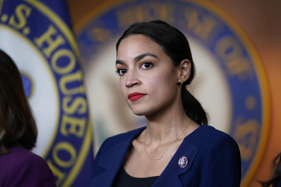 FILE - In this June 16, 2021, file photo Rep. Alexandria Ocasio-Cortez, D-N.Y., listens as House Speaker Nancy Pelosi, D-Calif., speaks during a news conference at the Capitol in Washington. One side is energized by the prospect of the greatest expansion of government support since the New Deal nearly a century ago. The other is fearful about dramatically expanding Washington's reach at an enormous cost. They are all Democrats, yet are taking vastly different approaches to the the massive $3.5 trillion spending bill moving through Congress. (AP Photo/J. Scott Applewhite, File)