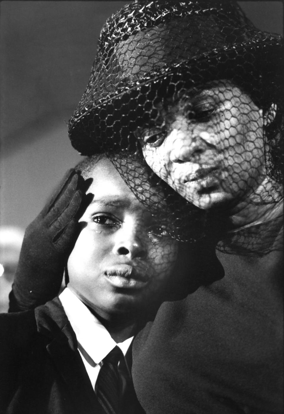 This 1964 photo taken by Bill Eppridge and released courtesy of Monroe Gallery shows Fannie Lee Chaney, right, and her son Ben Chaney at the funeral for her older son James Earl Chaney, in Meridian, Miss. James Earl Chaney, 21, was one of three American civil rights workers who were murdered during Freedom Summer. Photojournalist Bill Eppridge, whose legendary career included capturing images of a mortally wounded Robert Kennedy, the Beatles and the civil rights movement, died Thursday, Oct. 3, 2013 in Danbury, Conn., after a brief illness. He was 75. (AP Photo/Monroe Gallery, Bill Eppridge)