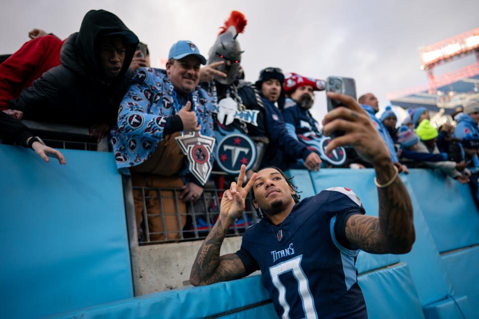 Tennessee Titans cornerback Sean Murphy-Bunting (0) takes a selfie with fans after defeating Jacksonville Jaguars 28-20 at Nissan Stadium in Nashville, Tenn., Sunday, Jan. 7, 2024.