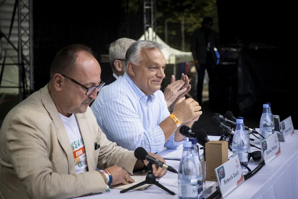 In this picture issued by the Hungarian PM's Press Office, Chairman of the Foreign Committee of the Hungarian Parliament Zsolt Nemeth, left, Hungarian Prime Minister Viktor Orban, center, and President of the Hungarian National Council of Transylvania Laszlo Tokes attend the 33th Balvanyos Summer University and Students' Camp in Baile Tusnad, Transylvania, Romania, Saturday, July 27, 2024. (Zoltan Fischer/Hungarian PM's Press Office/MTI via AP)