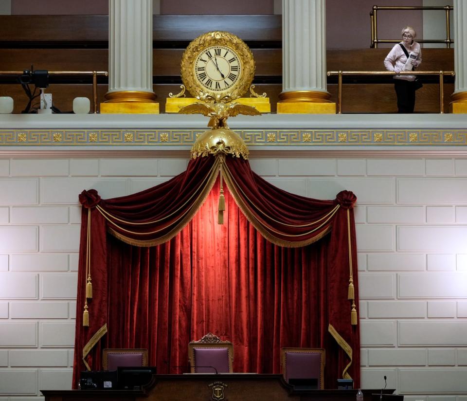 A visitor looks down from the balcony at the empty House chamber in December.