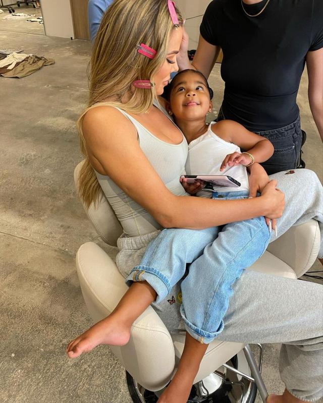 Khloe Kardashian shows off slender pins in leggings while cradling daughter  True, three, in LA