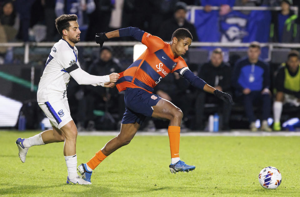 Creighton's Giorgio Probo, left, grabs the jersey of Syracuse's Amferny Sinclair during the second half of an NCAA men's soccer tournament semifinal in Cary, N.C., Friday, Dec. 9, 2022. (AP Photo/Ben McKeown)