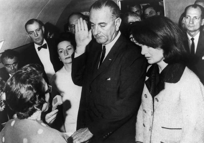 Vice President Lyndon B. Johnson is sworn in to the office of the Presidency aboard Air Force One in Dallas, Texas, hours after the assassination of President John F. Kennedy. 