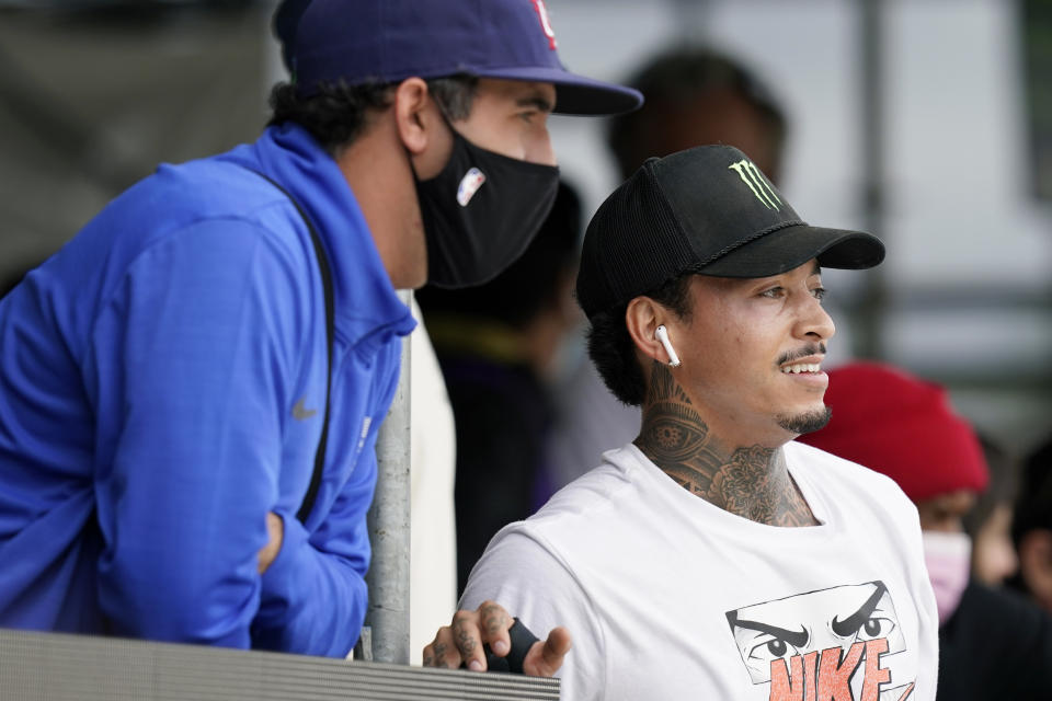 In this May 22, 2021, photo, Nyjah Huston, of the United States, right, looks on during practice for an Olympic qualifying skateboard event at Lauridsen Skatepark in Des Moines, Iowa. Where some skateboarders might be reluctant to move so boldly into the gargantuan realm of the Olympics, Huston is more than glad to latch on onto this monster. Tokyo might be the place where people outside the sport finally get a glimpse of one of the most interesting athletes around. (AP Photo/Charlie Neibergall)