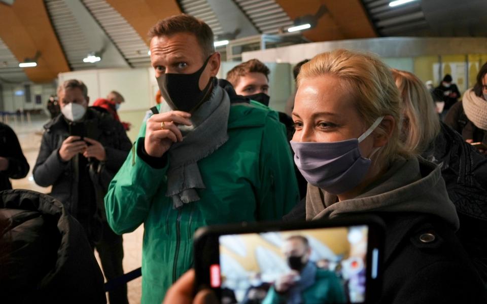 Alexei Navalny and his wife Yulia arriving in Russia yesterday - AP