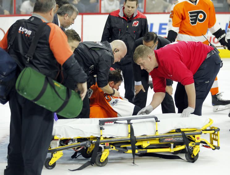 Philadelphia Flyers goalie Michal Neuvirth receives medical attention after apparently collapsing during the first period of the team's NHL hockey game agains the New Jersey Devils, Saturday, April 1, 2017, in Philadelphia. (AP Photo/Tom Mihalek)