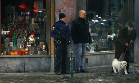Belgian police officers search the area during a continued high level of security following the recent deadly Paris attacks, in Brussels, Belgium, November 22, 2015. REUTERS/Francois Lenoir