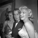 <p>Marilyn laughed with Humphrey Bogart and Lauren Bacall at the premiere of <em>How to Marry a Millionaire</em>. </p>