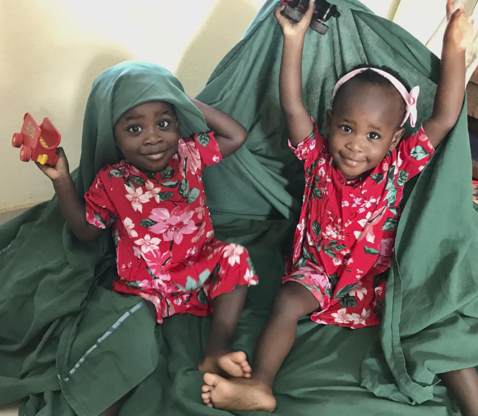 This March 30, 2020 family photo shows Claira, left, and Ariella Parker in Yaounde, Cameroon. Amid the coronavirus outbreak, the Parkers are stranded in Yaounde, waiting for the U.S. embassy to issue visas for the twin girls who were adopted in Chad in November 2018. (Michaela Parker via AP)