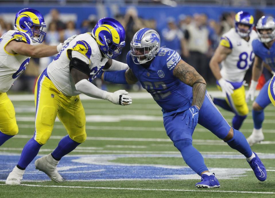 Rams guard Kevin Dotson blocks Detroit's James Mitchell during a playoff game last season.