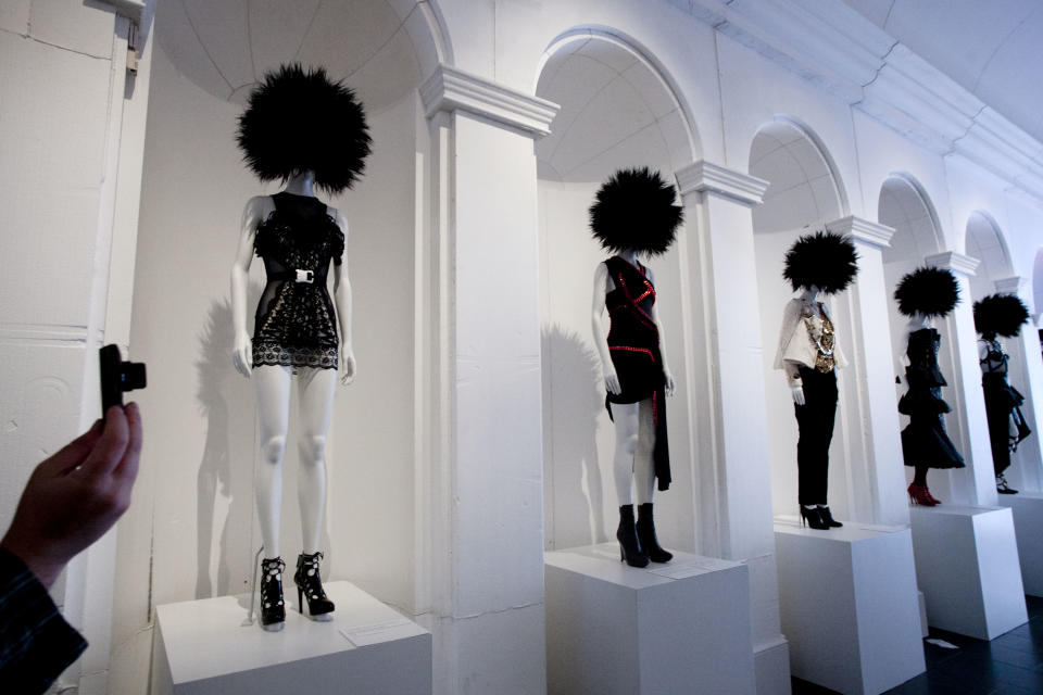 A visitor photographs the Metropolitan Museum of Art's exhibit, "Punk: Chaos to Couture," Monday, May 6, 2013 in New York. The show, which examines punk’s impact on high fashion from the movement’s birth in the 1970s through its continuing influence today, is open May 9 through August 14. (AP Photo/Mark Lennihan)