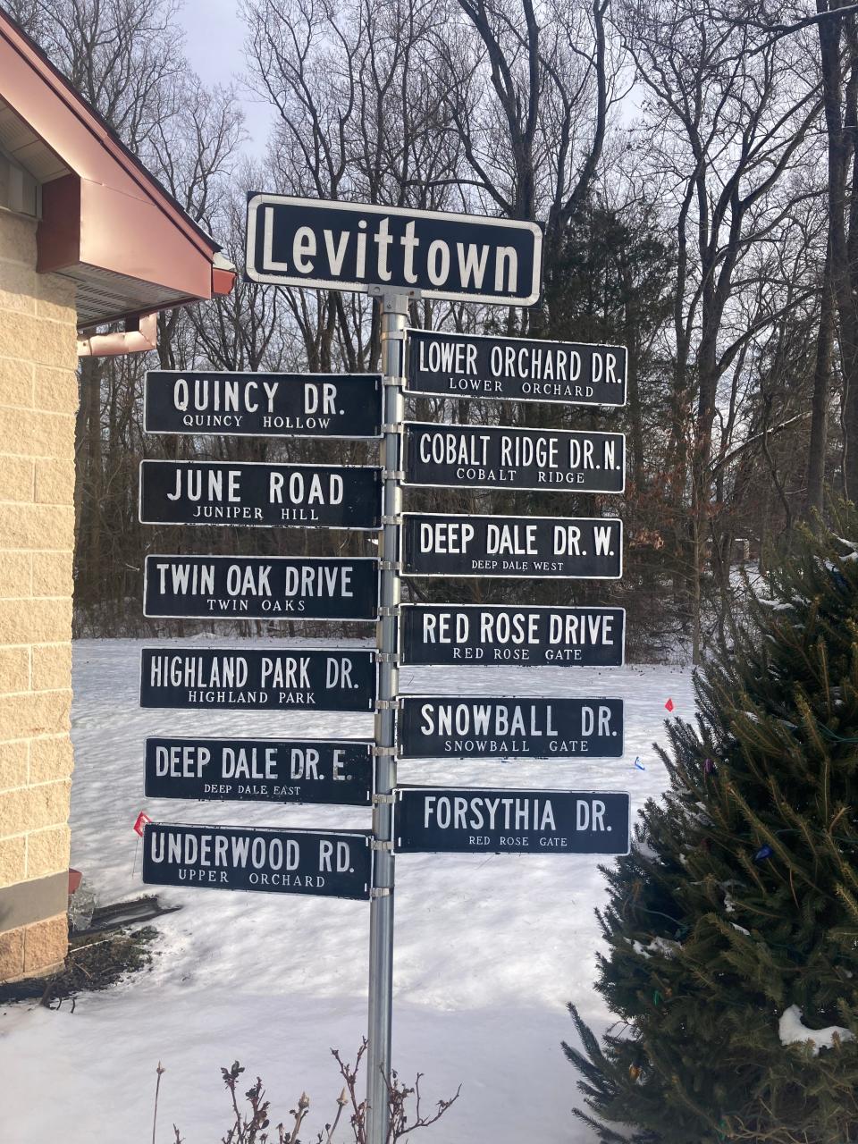 A collection of 1950s aluminum street signs from Levittown's early days, on display at an undisclosed location.