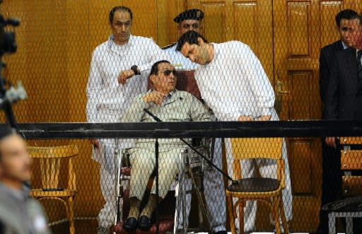 Former Egyptian president Hosni Mubarak, who faced multiple charges after his overthrow, including over the deaths of protesters in 2011 and for corruption, appeared with his two sons Alaa (R) and Gamal at their trial in Cairo in September 2013