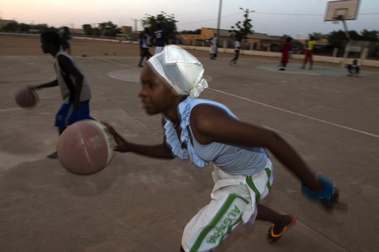 Fatoumata, 16, plays basketball at the former "Sharia Square" in central Gao, on February 26, 2013. Since the departure of the Islamists, who occupied the city for nine months, following the arrival of the French and Malian forces, the central square of Gao is once again called "Independence square."