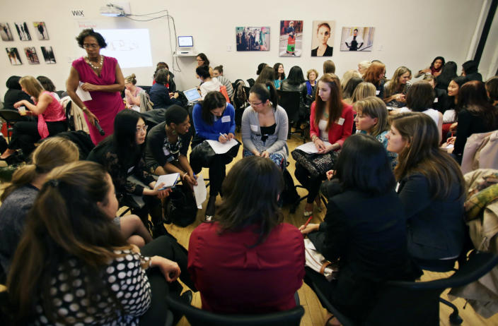 This April 16, 2013 photo provided by Wix Lounge shows group facilitator Franne McNeal, standing left,directing women attending a "lean in" circle in New York. The group is inspired by Facebook COO Sheryl Sandberg's book "Lean In" which seeks to empower women in the workplace. (AP Photo/Wix Lounge, Galo Delgado)