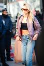 <p>Lily Donaldson flashed her abs in a short crop top and purple satin bomber jacket. <em>(Photo: Getty Images)</em> </p>