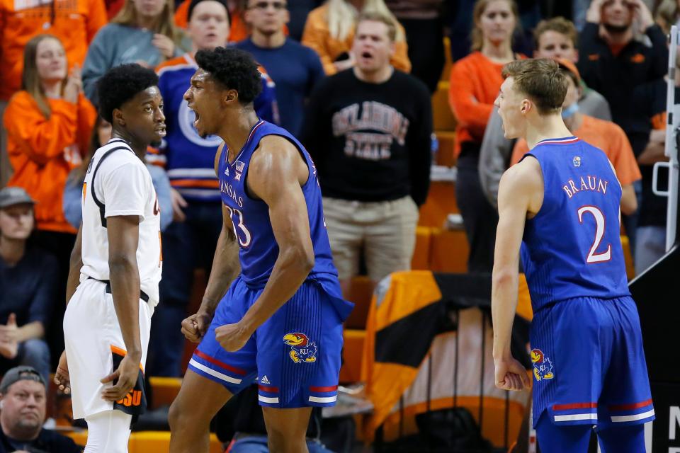 Kansas forward David McCormack (33) celebrates with Christian Braun (2) beside Oklahoma State guard Bryce Williams (14) during a game Tuesday Gallagher-Iba Arena in Stillwater, Oklahoma.