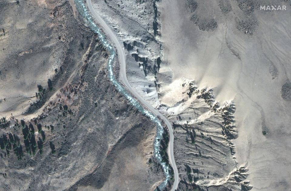 satellite image shows mountain road running alongside blue river in yellowstone