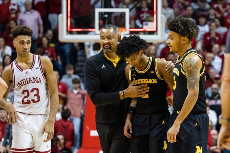 Michigan coach Juwan Howard leads his players off the court after losing in overtime against Indiana at Simon Skjodt Assembly Hall.