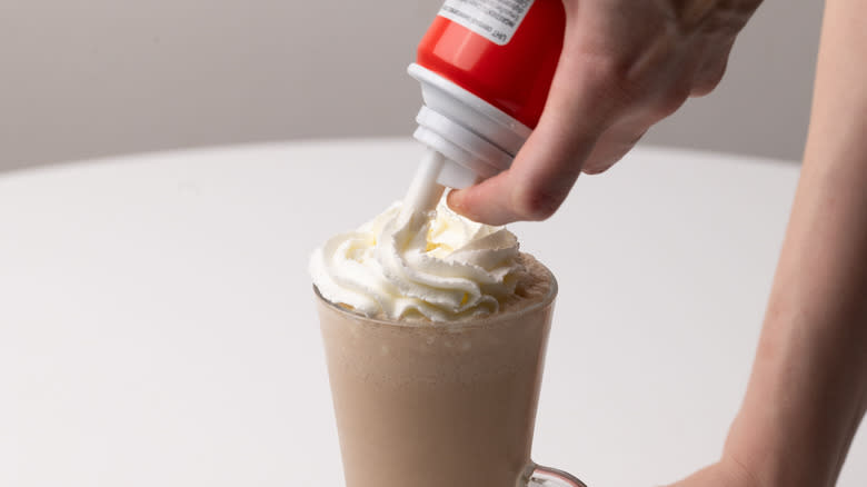 topping milkshake with whipped cream