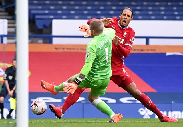 Everton goalkeeper Jordan Pickford tackles Liverpool defender Virgil Van Dijk