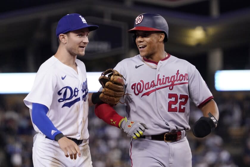 Los Angeles Dodgers' Trea Turner, left, and Washington Nationals' Juan Soto joke around after the end of the top of the seventh inning of a baseball game Monday, July 25, 2022, in Los Angeles. (AP Photo/Mark J. Terrill)
