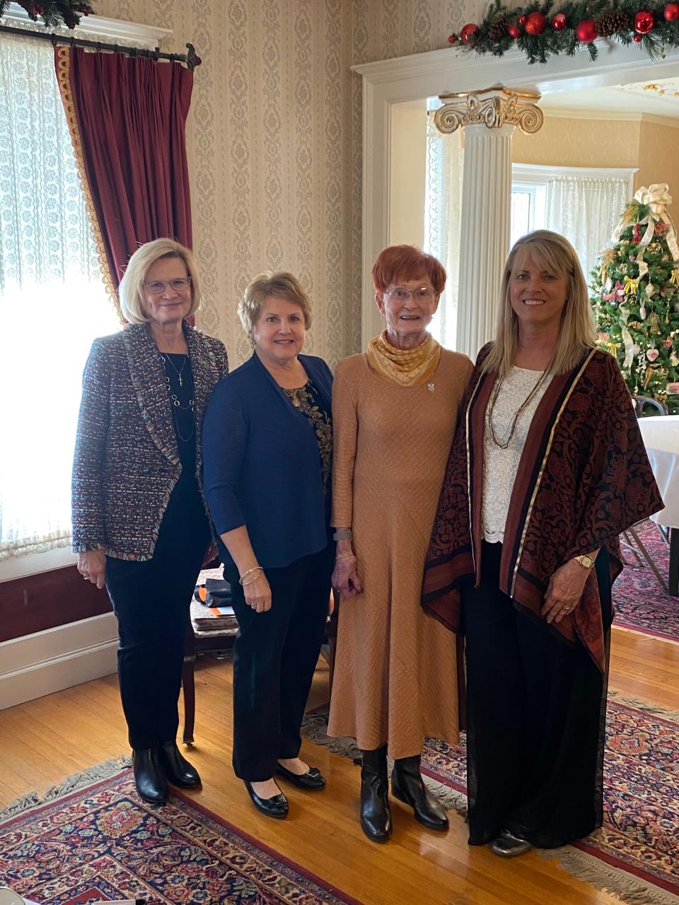 From left, Therese Miller, Karen Roberts, LaVetra Brown and Elizabeth Weese join together at the Fairy Godmother tea at the Seelye Mansion in Abilene. Brown was pinned as the first Fairy Godmother in Abilene after she donated to help other women in the community.