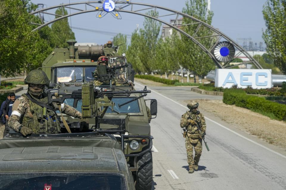 FILE - A Russian military convoy is seen on the road toward the Zaporizhzhia Nuclear Power Station, in Enerhodar, Zaporizhzhia region, in territory under Russian military control, southeastern Ukraine, on May 1, 2022. Workers at the Zaporizhzhia Nuclear Power Plant are recounting fears of being abducted and tortured or killed by Russian forces who seized control of the facility and the city of Enerhodar. Ukrainian officials say the Russians sought to intimidate the staff into keeping Europe's largest nuclear plant running, through beatings and other abuse. (AP Photo/File)