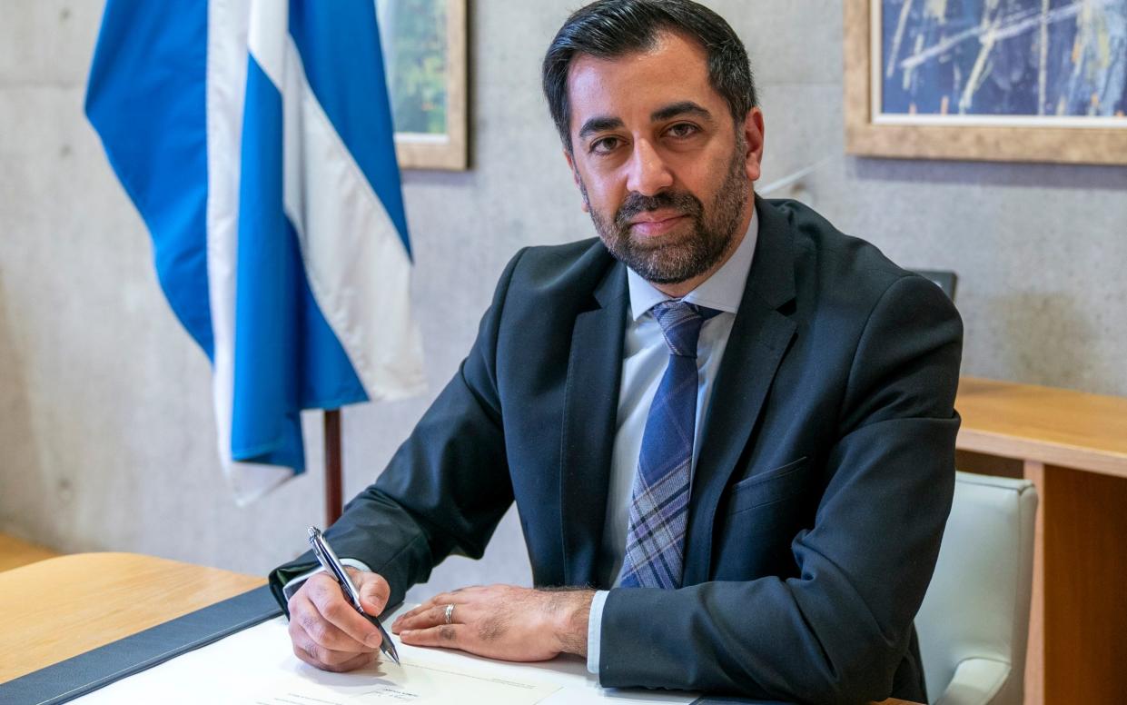 Humza Yousaf, the First Minister of Scotland, is pictured today signing his letter of resignation to the King