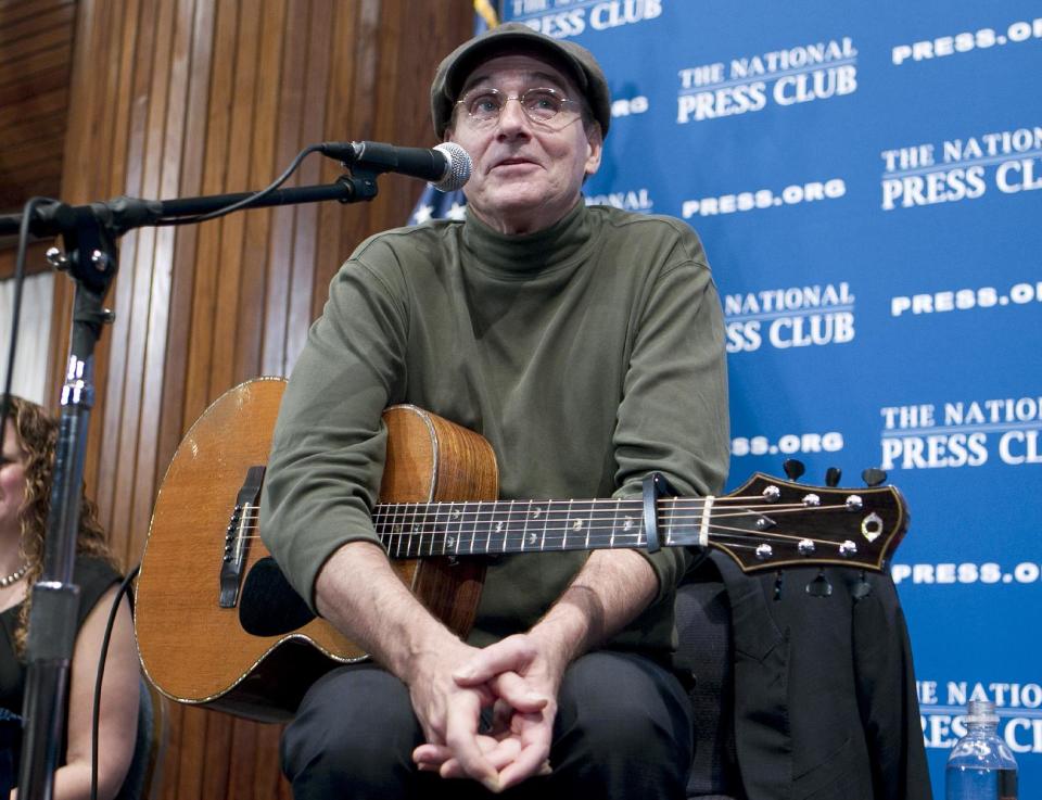 FILE - In this Dec. 7, 2012 file photo, Grammy Award-winning singer-songwriter James Taylor speaks during a news conference at the National Press Club in Washington, where talked about politics and music and entertained the crowd, a day after performing at 90th annual National Christmas Tree Lighting in Washington. Kelly Clarkson and fun. are just two of the acts who will perform during the upcoming inaugural festivities, which also includes Beyonce, James Taylor, Stevie Wonder, Katy Perry and dozens of others. (AP Photo/Jose Luis Magana, File)