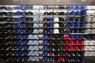 Fitted baseball caps are on display at the MLB Flagship store Wednesday, Sept. 30, 2020, in New York. Major League Baseball’s first retail store opens Friday. For now there is social distancing. Jerseys and caps are for sale, and there is a customization station, a lifestyle section, throwback attire, a Cooperstown area, game-used gear and a photo booth. (AP Photo/Frank Franklin II)