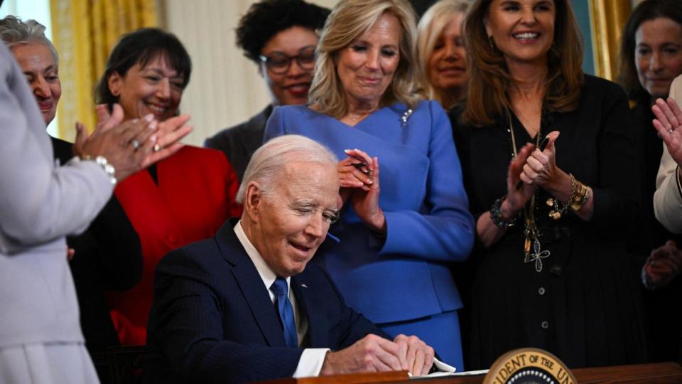 PHOTO: President Joe Biden signs an executive order aimed at advancing the study of women's health during a reception honoring Women's History Month in the East Room of the White House in Washington, DC, March 18, 2024. (Brendan Smialowski/AFP via Getty Images)