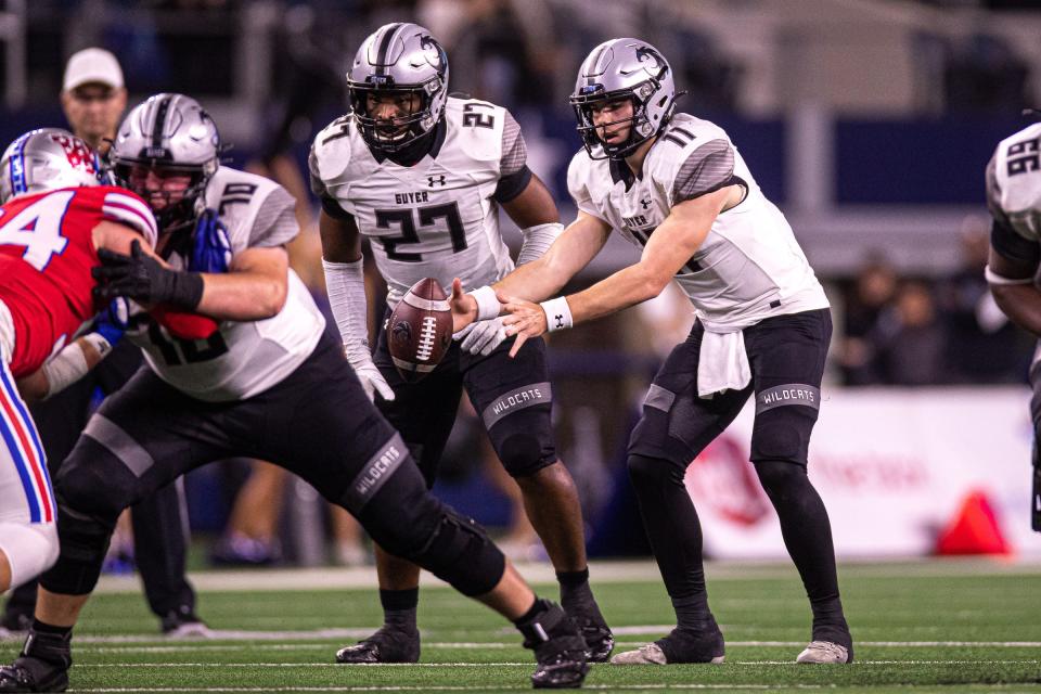 Guyer quarterback Jackson Arnold (11) snaps the ball against Westlake during the Class 6A Division 2 State Championship game at AT&T Stadium in Arlington, Texas on Dec. 18, 2021. Westlake defeated Guyer 40-21.