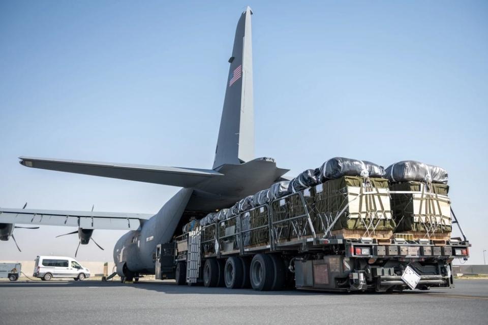 A US Air Force K-loader filled with pallets of Halal meals destined for an airdrop over Gaza is readied for load onto a C-130J Super Hercules.