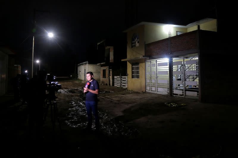 Members of the media work outside a drug rehabilitation facility where assailants killed several people according to Guanajuato state police, in Irapuato