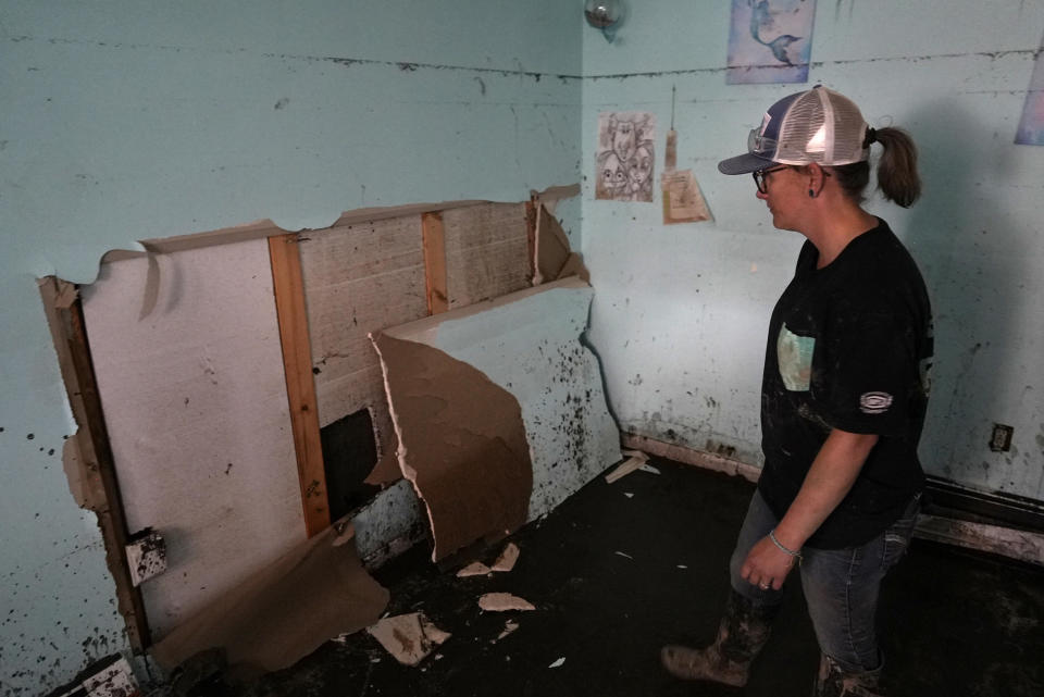 Alisha Beekman looks at soggy drywall in her daughter's bedroom Wednesday, June 15, 2022, in Red Lodge, Mont. Her home was one of hundreds in the small city that flooded when torrential rains swelled waterways across the Yellowstone region. / Credit: Brittany Peterson / AP
