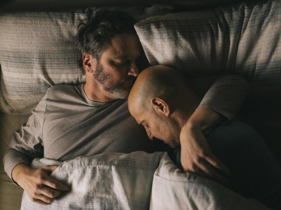 Sam (Colin Firth) and Tusker’s (Stanley Tucci) affections are expressed through gestures, not words – in how the two men’s bodies fold into each other as they sleep (Studiocanal)