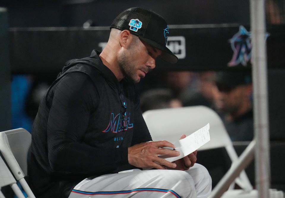 Feb 28, 2023; Jupiter, Florida, USA; Miami Marlins manager Skip Schumaker (55) goes over notes in the fourth inning during a game against the Boston Red Sox at Roger Dean Stadium. Mandatory Credit: Jim Rassol-USA TODAY Sports