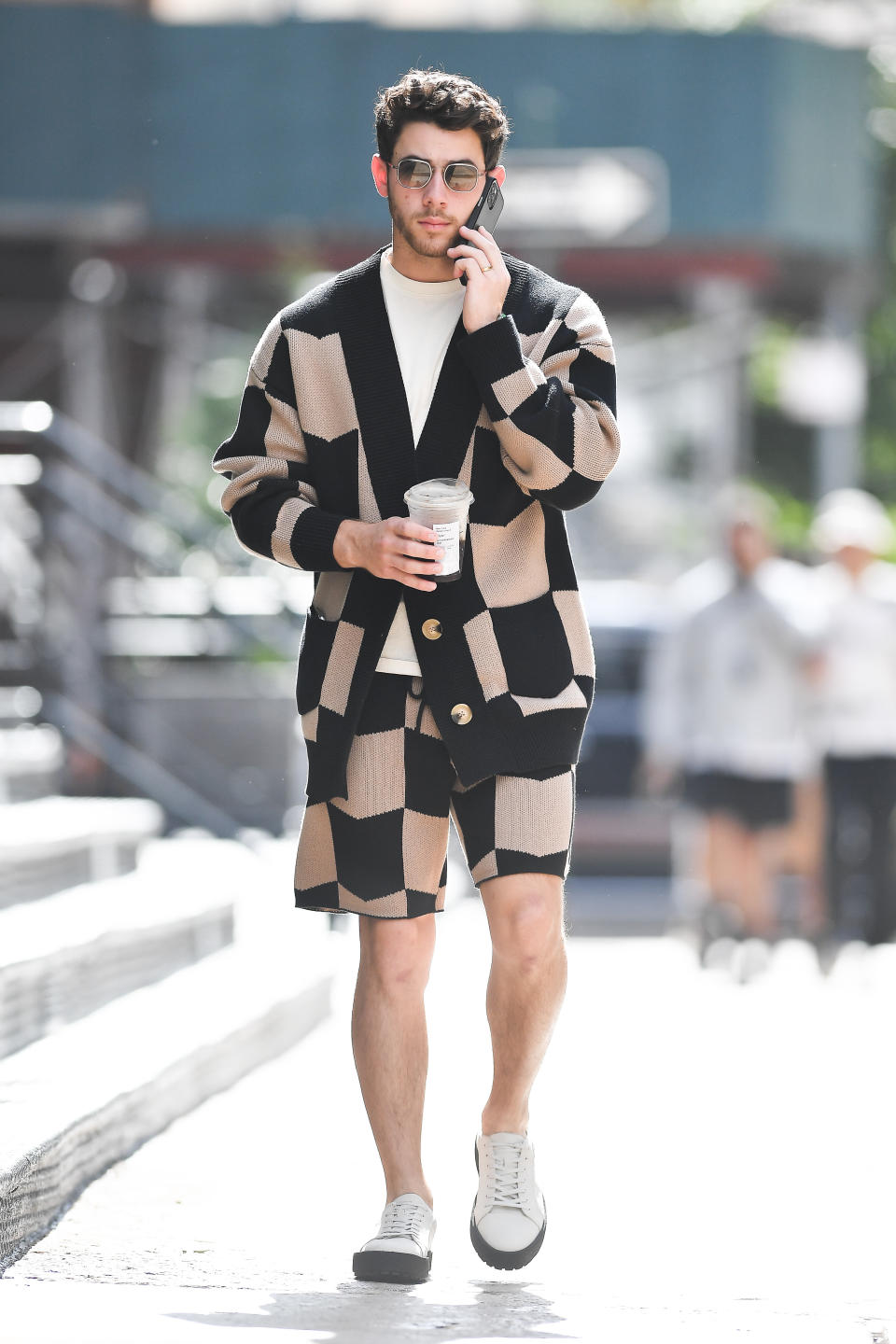 Nick Jonas wears a patterned outfit while grabbing a coffee in New York City. - Credit: Robert O' Neil / SplashNews.com