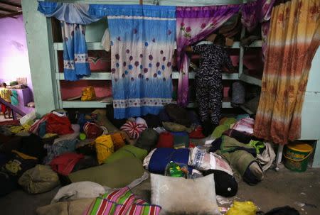 A jail guard searches through the belongings of detainees for illegal contraband inside the Manila City Jail in metro Manila, Philippines October 16, 2017. REUTERS/Romeo Ranoco