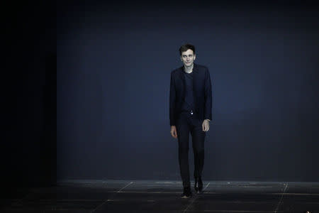 French designer Hedi Slimane appears at the end of his Spring/Summer 2013 women's ready-to-wear fashion show for French fashion house Saint Laurent Paris during Paris fashion week in this October 1, 2012 file photo REUTERS/Gonzalo Fuentes/Files