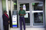 An elderly man waits to withdraw cash from a bank in Harare, Zimbabwe, Tuesday April 30, 2024. Zimbabwe introduced the world's newest currency in April introduced the world's newest currency in April, the ZiG, or Zimbabwe Gold. (AP Photo/Tsvangirayi Mukwazhi)