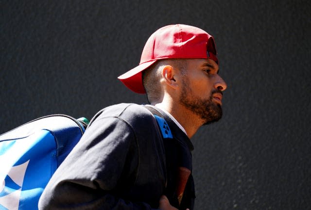 Nick Kyrgios walks across the players bridge